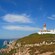 A lighthouse on a cliff that overlooks the ocean